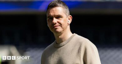 Close up image of Marc Skinner wearing in-ear headphones