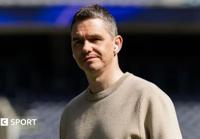 Close up image of Marc Skinner wearing in-ear headphones
