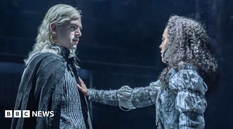 Noah Ritter (Prince Rhaegar Targaryen) and Harmony Rose-Bremner (Lyanna Stark) facing each other in costume in a scene from Game of Thrones: The Mad King. She has an arm outstretched with her palm on his chest