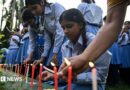 Mourners and students light candles to offer their condolences after the death of mountaineer Nirmal Purja 