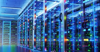 Modern data center with racks of cabinets and colored lights.