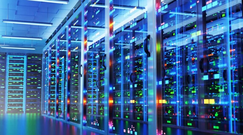 Modern data center with racks of cabinets and colored lights.