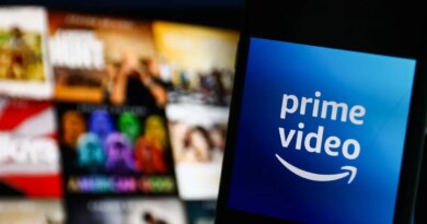 The logo of Amazon Prime Video against a blurred backdrop of tiles on a television screen.