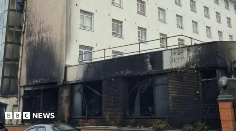 The front of a hotel damaged by fire.