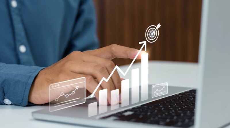 Businessman tracking corporate growth and hitting financial business targets on a laptop
