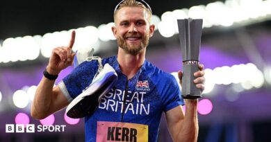Josh Kerr celebrates while holding the 1500m trophy after winning the inaugural World Athletics Ultimate Champion event in Budapest, Hungary