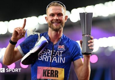 Josh Kerr celebrates while holding the 1500m trophy after winning the inaugural World Athletics Ultimate Champion event in Budapest, Hungary