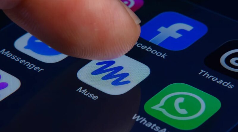 A close-up of a human finger pressing the Muse app icon inside a folder containing Meta apps on a smartphone screen.