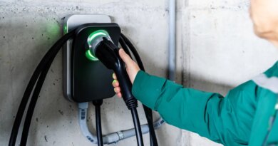 A man grabs an EV charger.