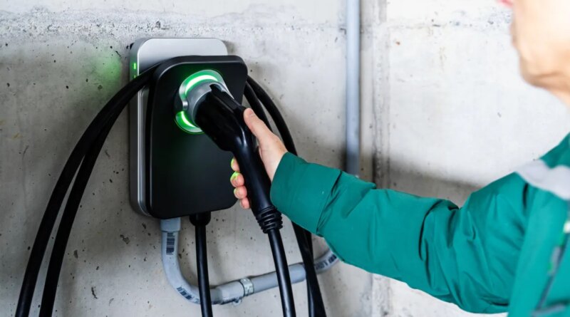 A man grabs an EV charger.