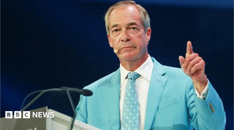 Nigel farage, wearing a light blue suit and white shirt, gestures with his left hand