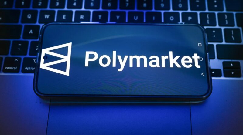 In this photo illustration, a Polymarket logo is displayed on a smartphone on top of a laptop.
