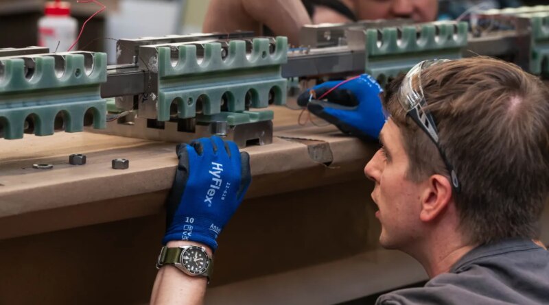 An engineer inspects a fusion power component.