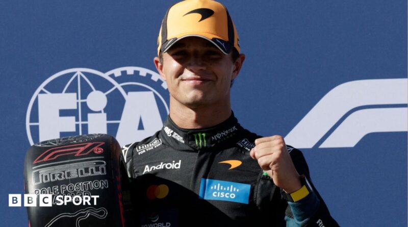 Lando Norris clenches his left fist in celebration while holding the pole position award at the Spanish Grand Prix