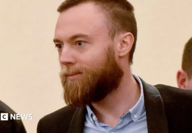 Jack Shepherd in court. He wears a shirt and jacket and has a beard