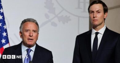 Steve Witkoff (left) and Jared Kushner (right) stand side by side looking directly towards the camera. They are both in black suits with white shirts. Witkoff has a blue patterned tie and Kushner has a black tie