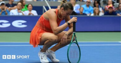 Aryna Sabalenka crouches over her racquet at the US Open