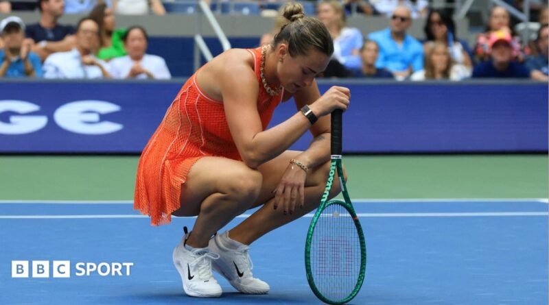 Aryna Sabalenka crouches over her racquet at the US Open