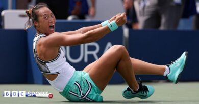 Qinwen Zheng falls to the ground in celebration after beating Madison Keys