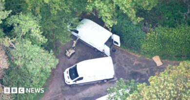 Aerial footage of robot and white vans near RAF Fairford