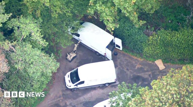 Aerial footage of robot and white vans near RAF Fairford