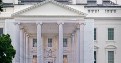 A protective tarp with a photo on it covers the scaffolding and the columns on the North Portico of the White House on July 18, 2026 in Washington, DC..