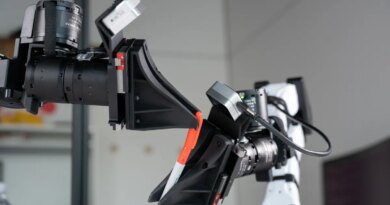 XDOF's robotic arms manipulate a pen and cap.