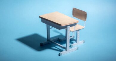Empty school desk on a blue background.