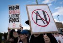 A sign opposed to AI is held during a protest against AI data centers in Vancouver, British Columbia, Canada, on Saturday, June 27, 2026. Canadians aren't universally sold on building sovereign compute, with early signs of protest against AI server farms in British Columbia and Manitoba. Photographer: Ethan Cairns/Bloomberg via Getty Images
