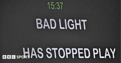 Message telling spectators bad light has stopped play is shown on the big screen
