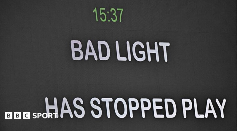 Message telling spectators bad light has stopped play is shown on the big screen