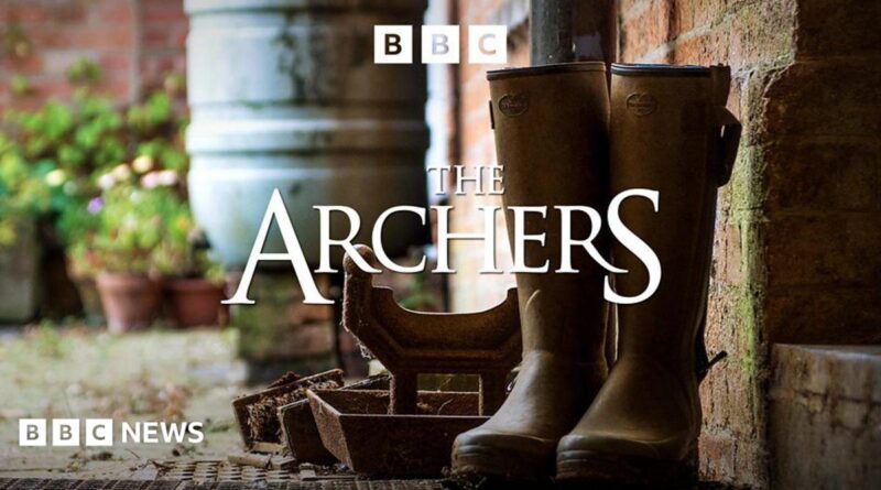 A pair of brown Wellington boots are visible next to a brick wall. The image is emblazoned with the words "The Archers".