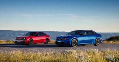 A blue and red car are parked next to each other.