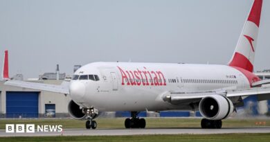 An Austrian Airlines jet on a landing runway.