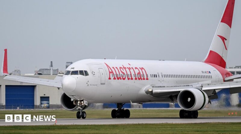 An Austrian Airlines jet on a landing runway.