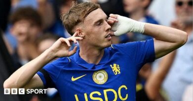 Cole Palmer puts his fingers to his ears after scoring for Chelsea