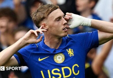 Cole Palmer puts his fingers to his ears after scoring for Chelsea