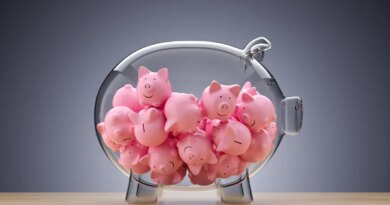 glass piggy bank full of little pink piggies