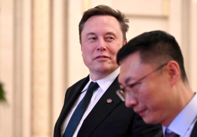Tech billionaire and Tesla founder Elon Musk walks through the Great Hall of the People.