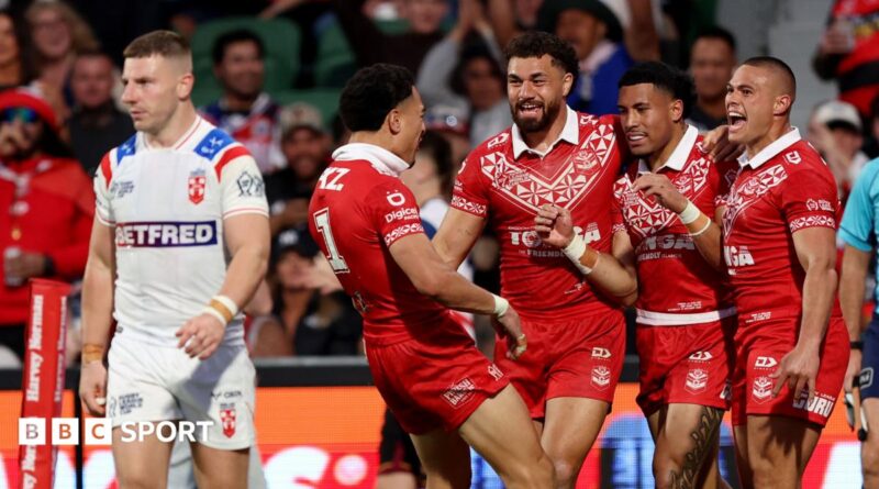 George Williams looks dejected as Tonga celebrate