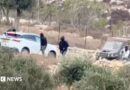 Vehicles at the site where Belgium's foreign minister says masked settlers in the Israeli-occupied West Bank attacked Palestinians, Catholic representatives and Western diplomats and officials.