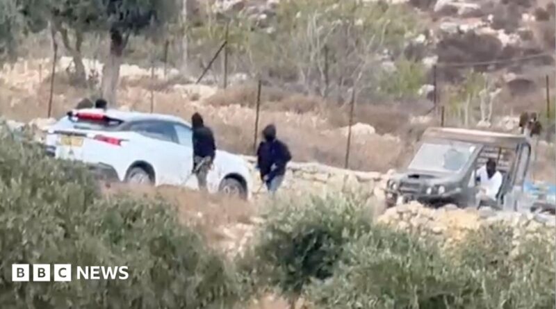 Vehicles at the site where Belgium's foreign minister says masked settlers in the Israeli-occupied West Bank attacked Palestinians, Catholic representatives and Western diplomats and officials.
