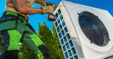 HVAC Technician Installing Large Modern Heat Pump