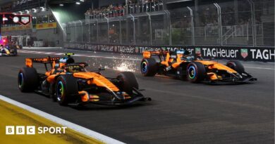 Lando Norris and Oscar Piastri move away at the start of the Singapore Grand Prix