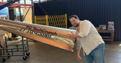 Longshot CEO and cofounder Mike Grace with a projectile designed to be fired from his company's enormous gun.