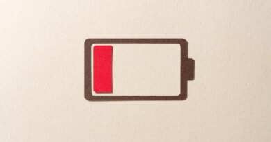 Paper Cut Craft Battery Only Has One Red Cell Left on Beige Background Directly Above View.