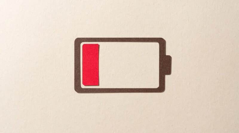 Paper Cut Craft Battery Only Has One Red Cell Left on Beige Background Directly Above View.