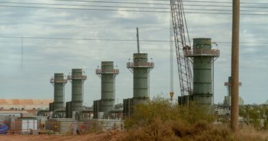 Five smoke stacks stand at a construction site in Texas.