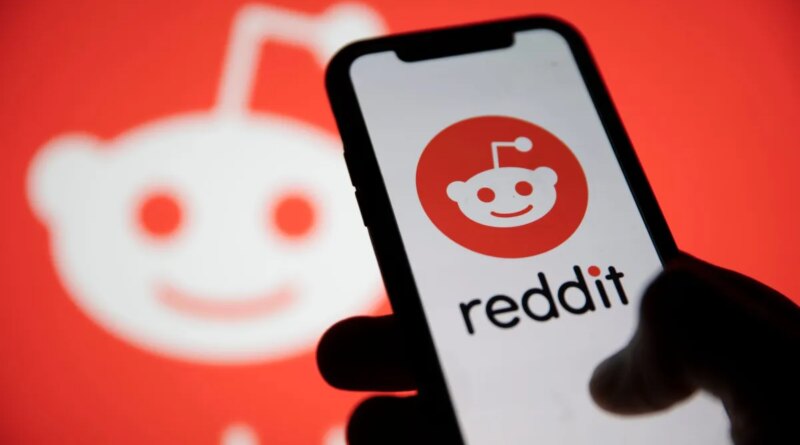 Reddit logo displayed on smartphone with Reddit logo in the background