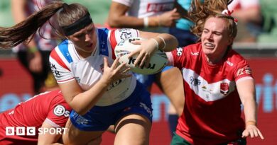 Connie Boyd holds on to the ball as two Wales players look to halt her progress